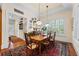 Charming dining room features a wood table, a vintage rug, and windows providing natural light at 585 Old Cobblestone Dr, Atlanta, GA 30350