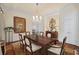 Formal dining room with chandelier, wood table, hardwood floors and an ornate mirror at 585 Old Cobblestone Dr, Atlanta, GA 30350
