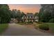 Beautiful home with a manicured lawn, stone accents, and a welcoming driveway create a captivating curb appeal at 585 Old Cobblestone Dr, Atlanta, GA 30350