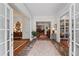 Elegant foyer featuring stone flooring, high ceilings, and views into the adjoining living spaces and detailed trim at 585 Old Cobblestone Dr, Atlanta, GA 30350