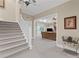 Open foyer with staircase leads to a cozy living room with fireplace and backyard views at 585 Old Cobblestone Dr, Atlanta, GA 30350