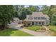 Stately home with a stone driveway and professionally landscaped front yard and a three car garage at 585 Old Cobblestone Dr, Atlanta, GA 30350