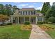 Inviting front porch with stone walkway, grand columns, and manicured landscaping creating a warm, welcoming entrance at 585 Old Cobblestone Dr, Atlanta, GA 30350