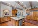 Kitchen with custom wood cabinets, stone countertops, and stainless steel appliances at 585 Old Cobblestone Dr, Atlanta, GA 30350