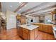 Gourmet kitchen with granite countertops and wood beam ceiling at 585 Old Cobblestone Dr, Atlanta, GA 30350