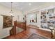 Upstairs landing with wood floors, decorative rug, and built-in bookcases at 585 Old Cobblestone Dr, Atlanta, GA 30350