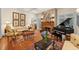 Inviting living room features a fireplace, grand piano, and comfortable seating with ample natural light at 585 Old Cobblestone Dr, Atlanta, GA 30350