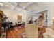 Cozy living room with fireplace, grand piano, and wooden floors offers a comfortable gathering space at 585 Old Cobblestone Dr, Atlanta, GA 30350