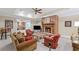 Cozy living room features a brick fireplace, ceiling fan, and comfortable seating arrangement at 585 Old Cobblestone Dr, Atlanta, GA 30350