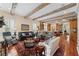 Open living room with hardwood floors, wood beams, and access to kitchen at 585 Old Cobblestone Dr, Atlanta, GA 30350