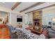 Cozy living room with stone fireplace, wood beams, built-ins, and hardwood floors at 585 Old Cobblestone Dr, Atlanta, GA 30350