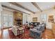 Bright and airy living room with stone fireplace, wood beams, and hardwood floors at 585 Old Cobblestone Dr, Atlanta, GA 30350