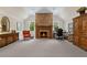 Large living room with brick fireplace, natural light, and office space at 585 Old Cobblestone Dr, Atlanta, GA 30350