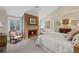 Charming main bedroom with brick fireplace, plush carpet, and natural lighting at 585 Old Cobblestone Dr, Atlanta, GA 30350