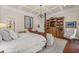 Spacious main bedroom featuring a four-poster bed, chandelier, and built-in bookshelves at 585 Old Cobblestone Dr, Atlanta, GA 30350