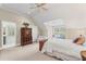 Bright main bedroom features a ceiling fan, ensuite bathroom, and sunny window at 585 Old Cobblestone Dr, Atlanta, GA 30350