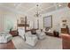 Bright main bedroom with tray ceiling, four-poster bed, and seating area at 585 Old Cobblestone Dr, Atlanta, GA 30350