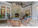 Inviting covered patio featuring a stone fireplace and comfortable seating, perfect for outdoor relaxation at 585 Old Cobblestone Dr, Atlanta, GA 30350
