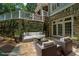 Secluded outdoor patio with comfortable seating, perfect for enjoying the landscaped surroundings at 585 Old Cobblestone Dr, Atlanta, GA 30350