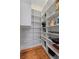 Walk-in pantry with floor-to-ceiling white shelves and hardwood flooring at 585 Old Cobblestone Dr, Atlanta, GA 30350