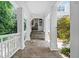 Covered front porch with stone flooring and white columns at 585 Old Cobblestone Dr, Atlanta, GA 30350