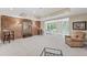 Bright recreation room with a brick accent wall, large mirror, and access to the backyard at 585 Old Cobblestone Dr, Atlanta, GA 30350