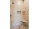 Walk-in shower featuring travertine tile and a built-in bench at 585 Old Cobblestone Dr, Atlanta, GA 30350