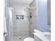 Modern bathroom with tiled walk-in shower featuring a built-in niche and neutral-colored decor at 1379 Branchwood Dr, Snellville, GA 30078