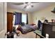 Bedroom with neutral walls, ceiling fan, one window, and furnished with bed, closet, and desk at 1379 Branchwood Dr, Snellville, GA 30078