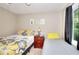 Cozy bedroom with two beds, bedside table, decorative pillows, and natural light from a window at 1379 Branchwood Dr, Snellville, GA 30078