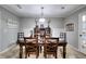 Traditional dining room featuring a wooden table, chairs, and display cabinet for storage and decor at 1379 Branchwood Dr, Snellville, GA 30078
