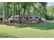 Well-manicured front lawn and mature trees surround this charming single-story home at 1379 Branchwood Dr, Snellville, GA 30078