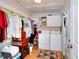 Functional laundry room with washer, dryer, storage shelves, and neutral decor at 1379 Branchwood Dr, Snellville, GA 30078