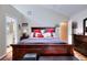 Well lit main bedroom featuring a queen size bed, two nightstands, and view into main bathroom at 1379 Branchwood Dr, Snellville, GA 30078