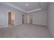 Large primary bedroom with tray ceiling, recessed lights, ensuite bathroom, and walk-in closet at 16 Deer Place, Villa Rica, GA 30180