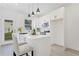 Bright kitchen features white cabinets, stainless appliances, quartz countertops, and an island with pendant lighting at 170 Chandler Trce, Covington, GA 30016