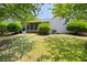 A grassy backyard with a partial view of the house, framed by shade trees and a wood fence at 4527 Baker Grove Nw Rd, Acworth, GA 30101