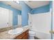 Charming bathroom featuring updated vanity and shower-tub combo with blue walls and granite countertop at 4527 Baker Grove Nw Rd, Acworth, GA 30101