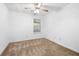 This bedroom features neutral walls, carpet flooring, a ceiling fan, and a bright window at 4527 Baker Grove Nw Rd, Acworth, GA 30101