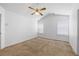 An open primary bedroom boasts neutral walls, a ceiling fan, carpeted floors, and natural light at 4527 Baker Grove Nw Rd, Acworth, GA 30101