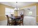 Formal dining room featuring carpeted floors and an open view into the living room at 4527 Baker Grove Nw Rd, Acworth, GA 30101