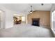 Bright living room featuring plush carpeting, a fireplace, and a ceiling fan at 4527 Baker Grove Nw Rd, Acworth, GA 30101