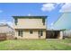 Rear view of the home showcasing a spacious backyard with a lush green lawn at 5292 Windfield Glen Nw Ct, Lilburn, GA 30047