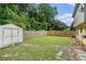 Large, grassy backyard with a fence and storage shed at 5292 Windfield Glen Nw Ct, Lilburn, GA 30047