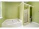 This bathroom features a separate bathtub and shower, with a white tile floor at 5292 Windfield Glen Nw Ct, Lilburn, GA 30047