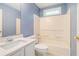 This bright bathroom offers a combined bathtub and shower and a vanity sink at 5292 Windfield Glen Nw Ct, Lilburn, GA 30047