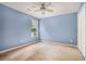 This cozy bedroom is painted with soft blue walls, a ceiling fan, and a built-in air conditioner at 5292 Windfield Glen Nw Ct, Lilburn, GA 30047