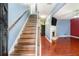 Inviting entryway with hardwood stairs, wood floors, and a view into the living room featuring a fireplace at 5292 Windfield Glen Nw Ct, Lilburn, GA 30047