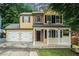 Charming two-story home with a welcoming front porch and a two-car garage, perfect for suburban living at 5292 Windfield Glen Nw Ct, Lilburn, GA 30047