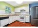 Functional kitchen with white cabinets, granite countertops, and essential appliances at 5292 Windfield Glen Nw Ct, Lilburn, GA 30047